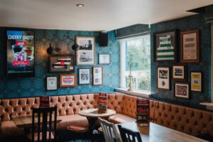 Sports memorabilia and seating inside a Grandstand sports pub