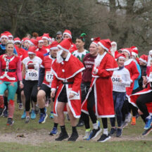 Participants in festive costumes at the Sutton Santa Run in Sutton Park, Sutton Coldfield.