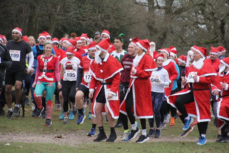 Participants in festive costumes at the Sutton Santa Run in Sutton Park, Sutton Coldfield.